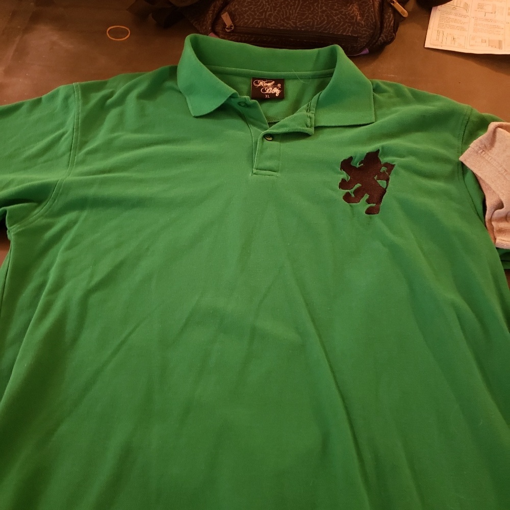 Green polo with a lion on the chest